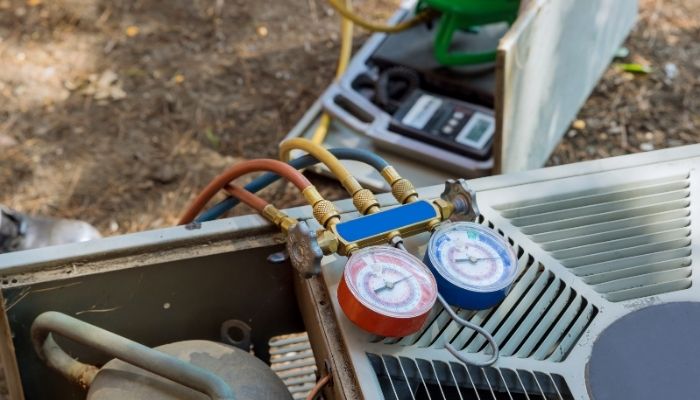 Outdoor HVAC unit receiving maintenance