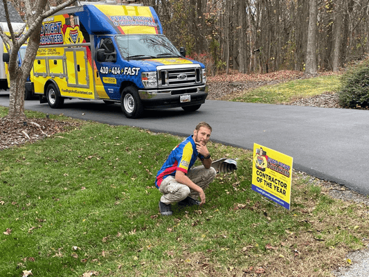 Fixed Right Hvac technician posing in front of a yard sign.